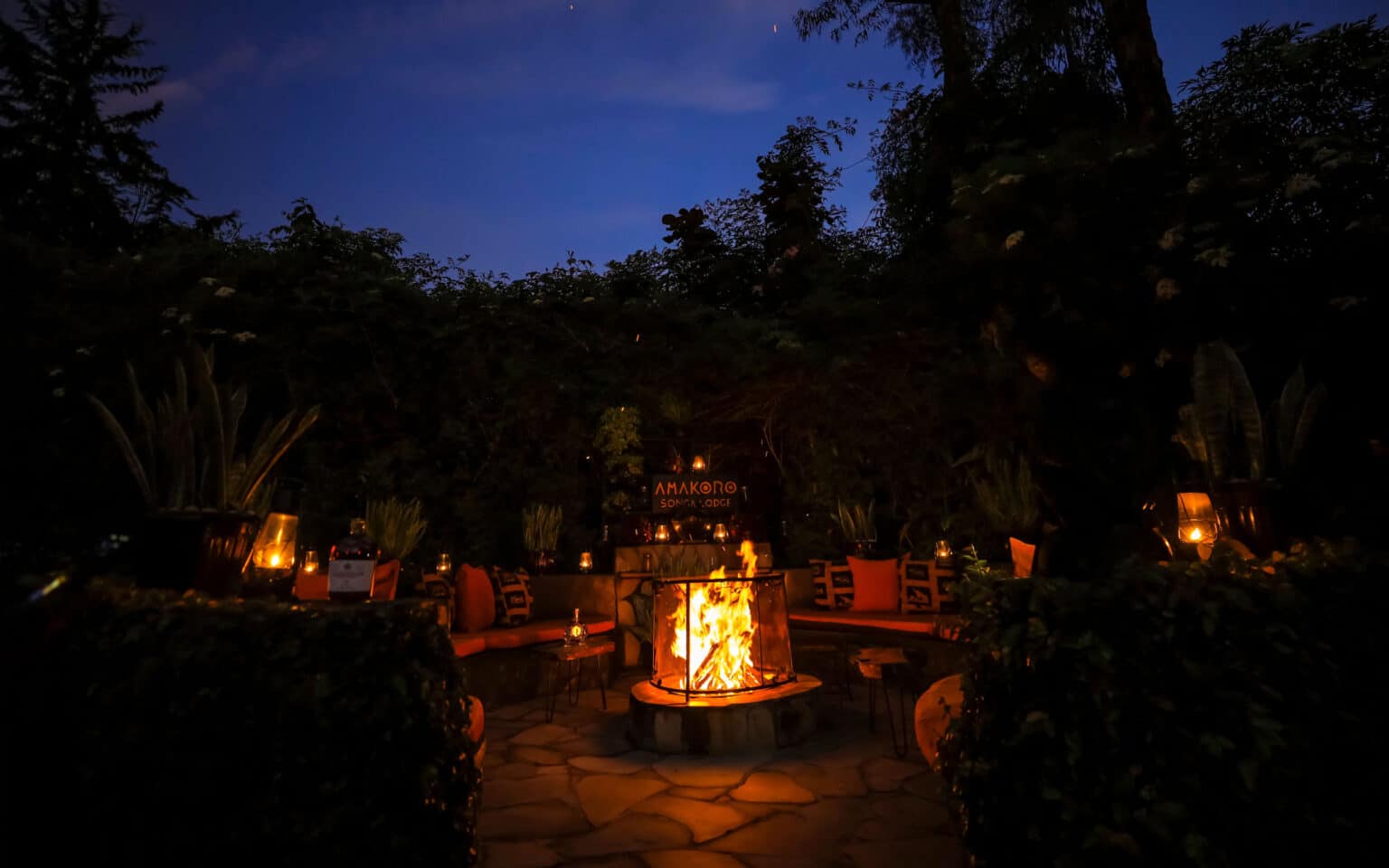 Cozy outdoor setting with a glowing fire pit at night