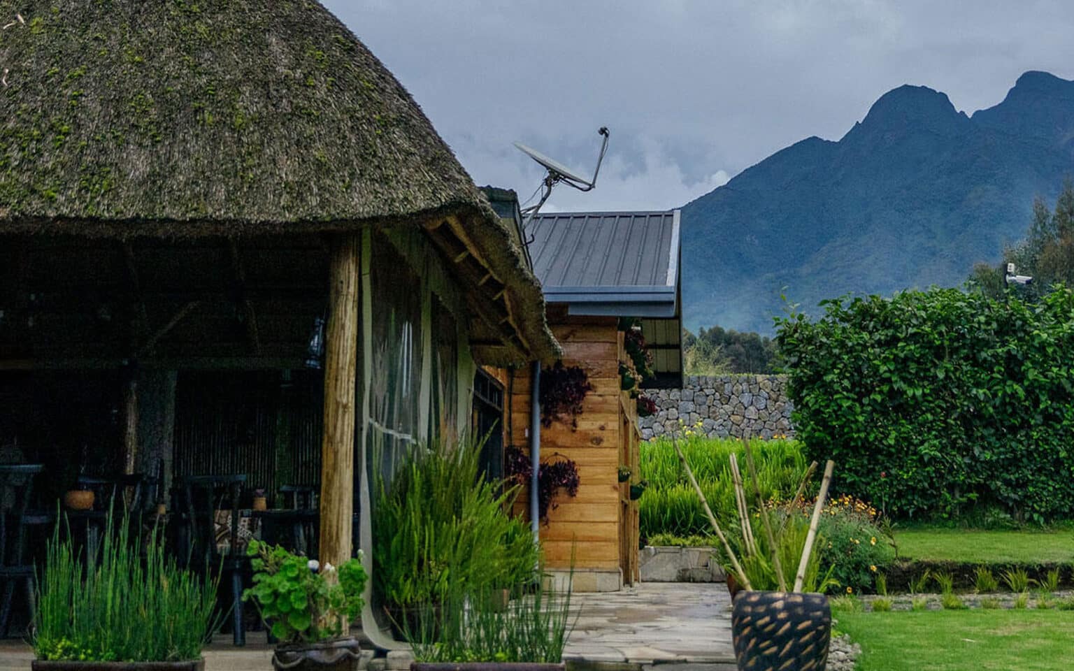 Rustic cabin with mountains and lush greenery