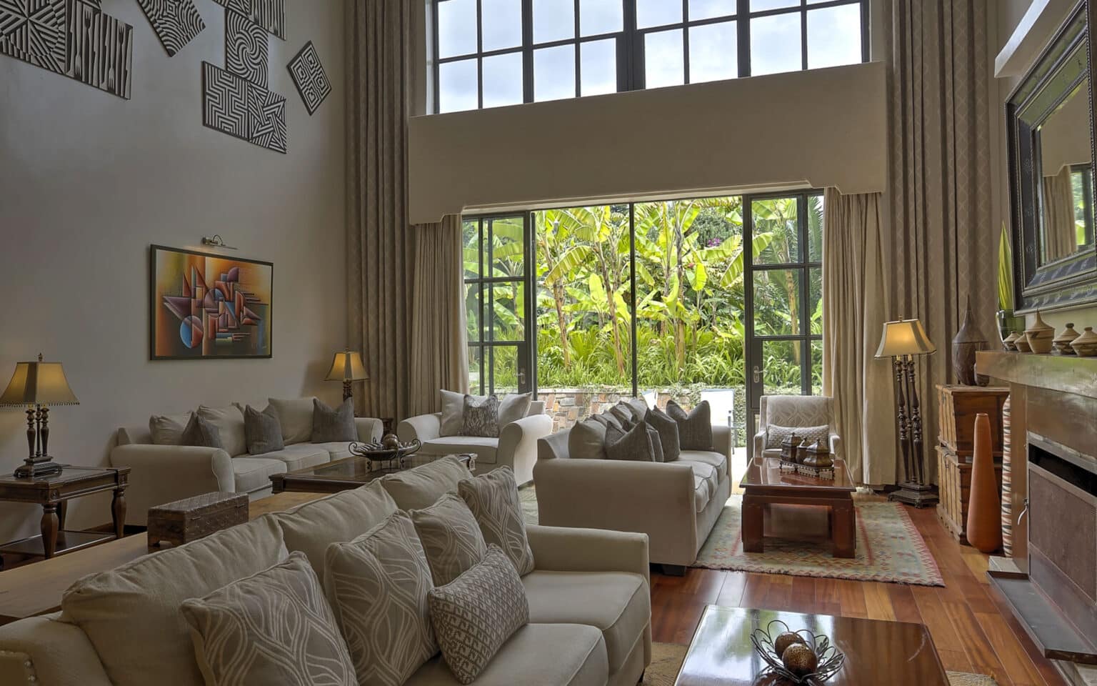 Spacious modern living room with large windows and cozy seating