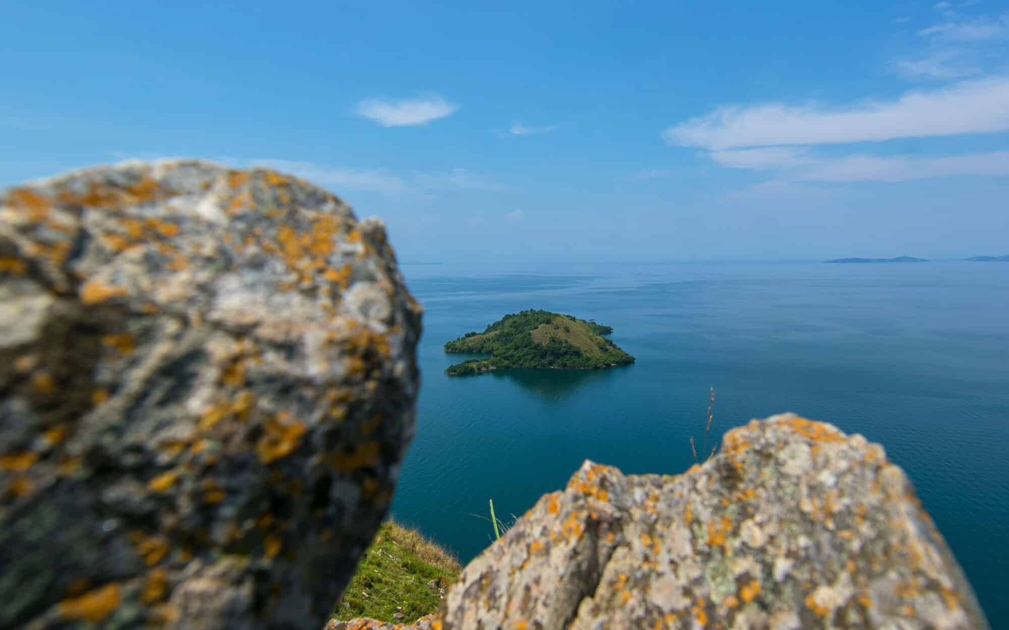Rocky viewpoint overlooking serene island and blue ocean scene