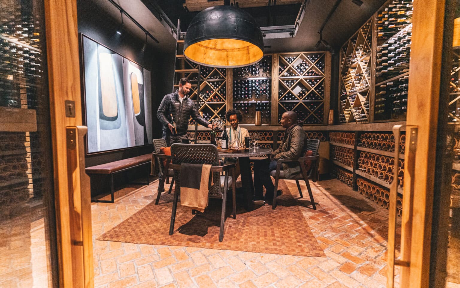 Men enjoying wine tasting in cozy cellar ambiance