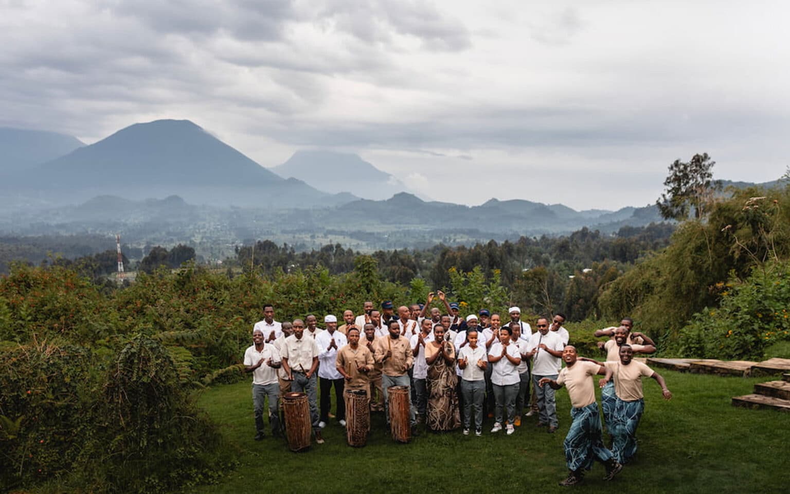 Group celebrating with drums in scenic mountain landscape